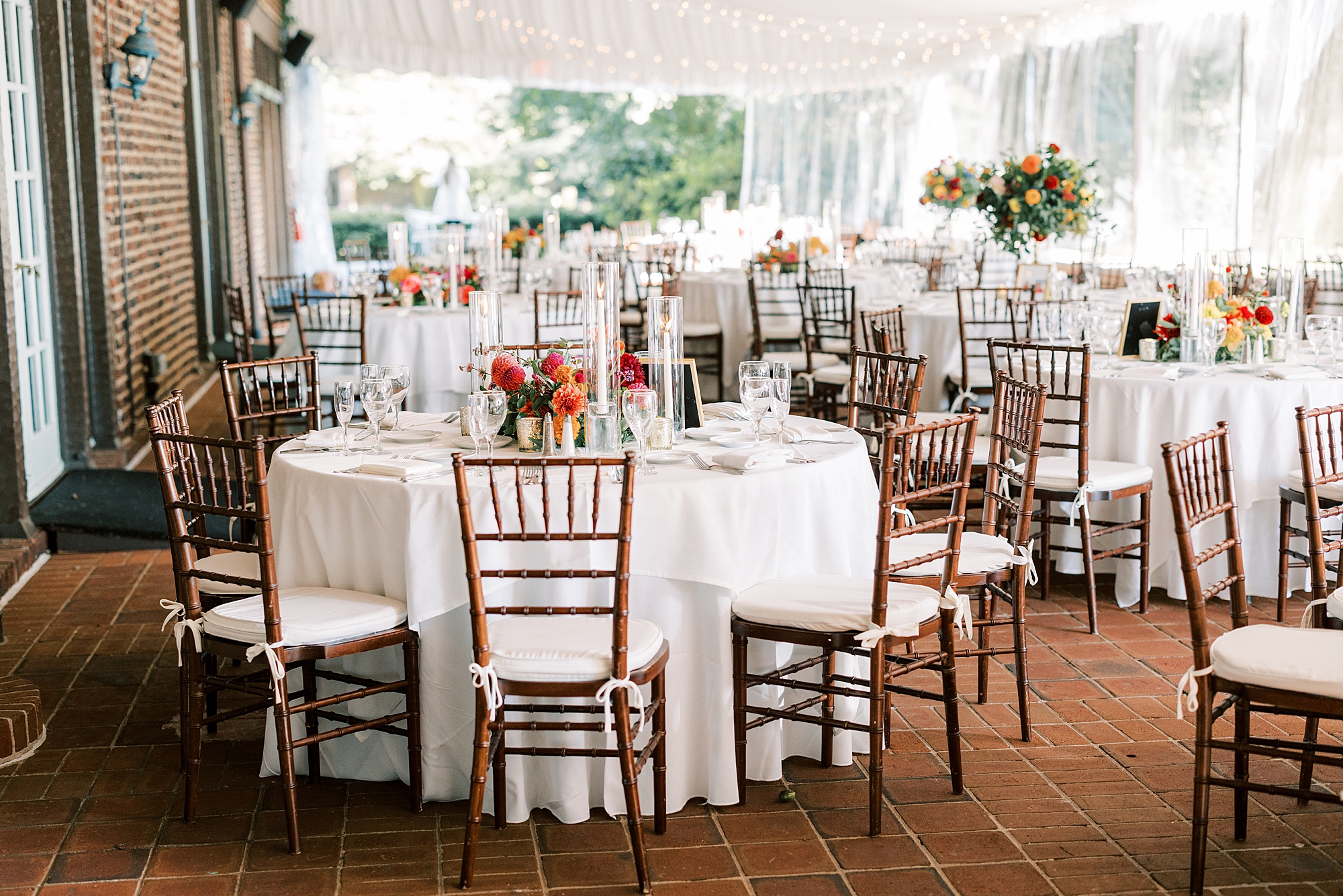 wedding reception on patio at Greenville Country Club with bright floral centerpieces 