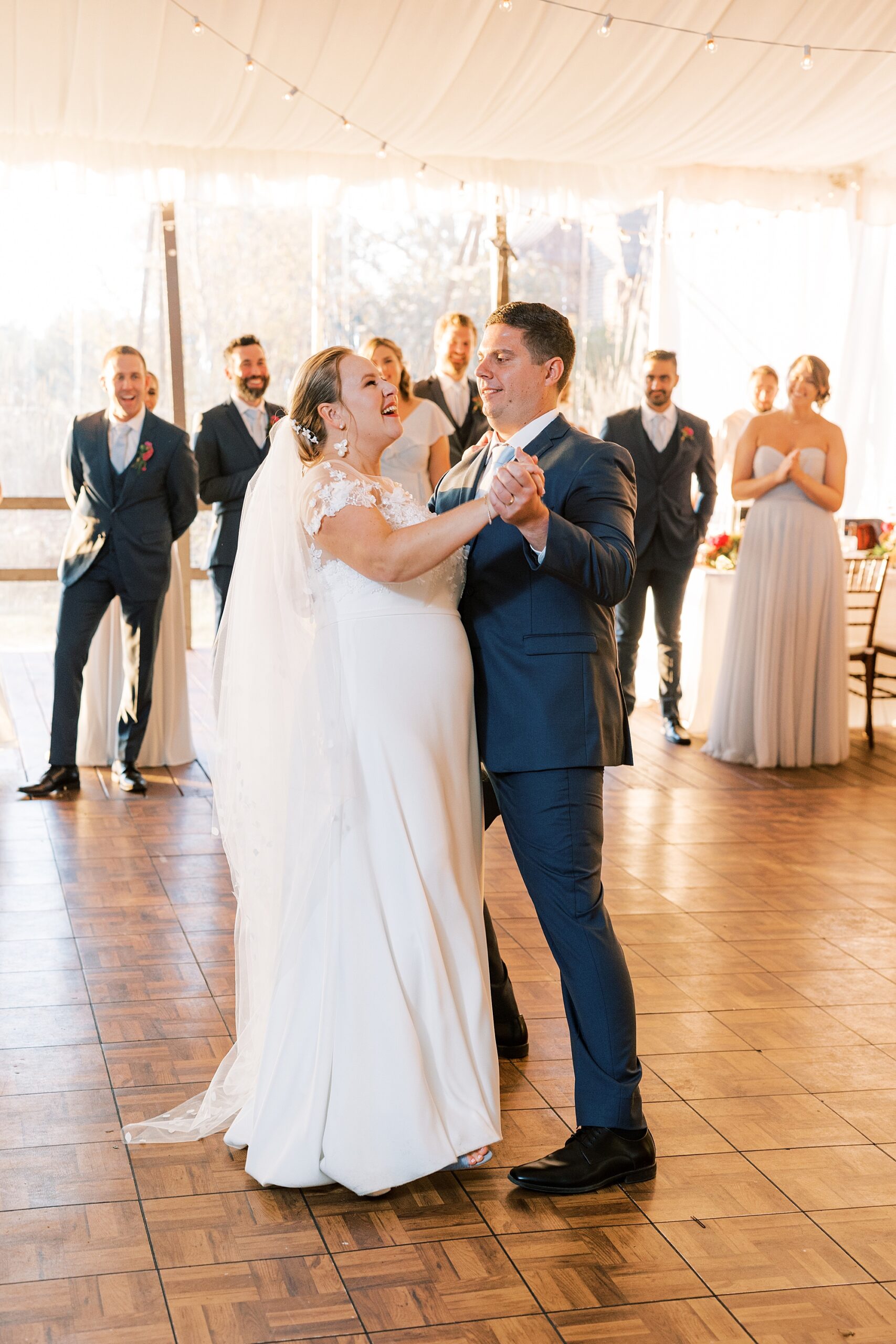bride and groom dance together during wedding reception 