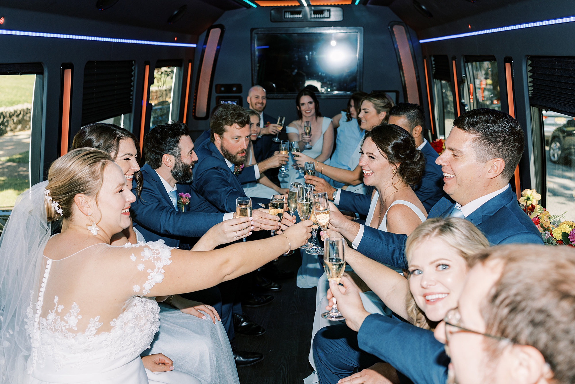 bride and groom toast champagne in limo 