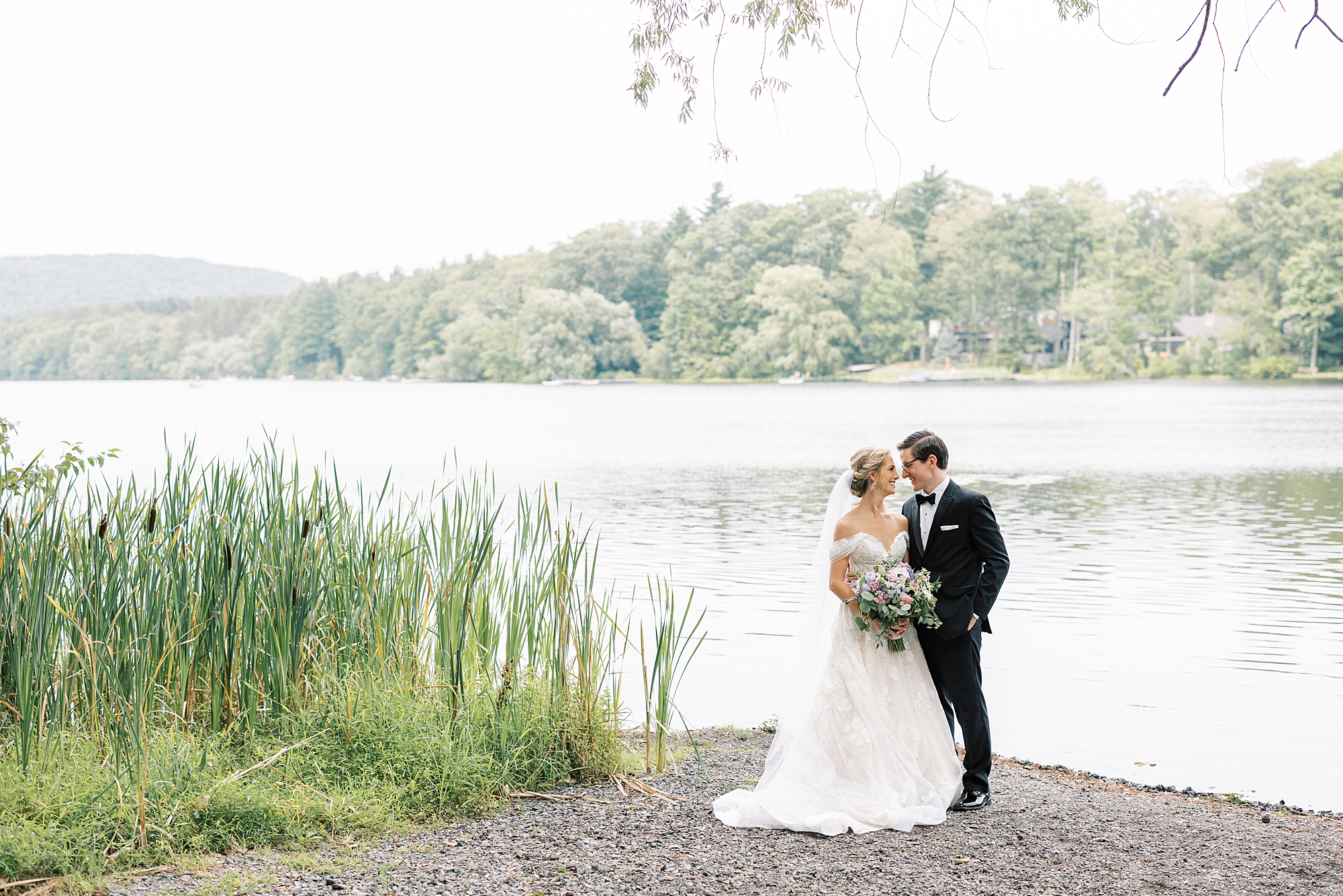 bride and groom kiss by lake at Skytop Lodge