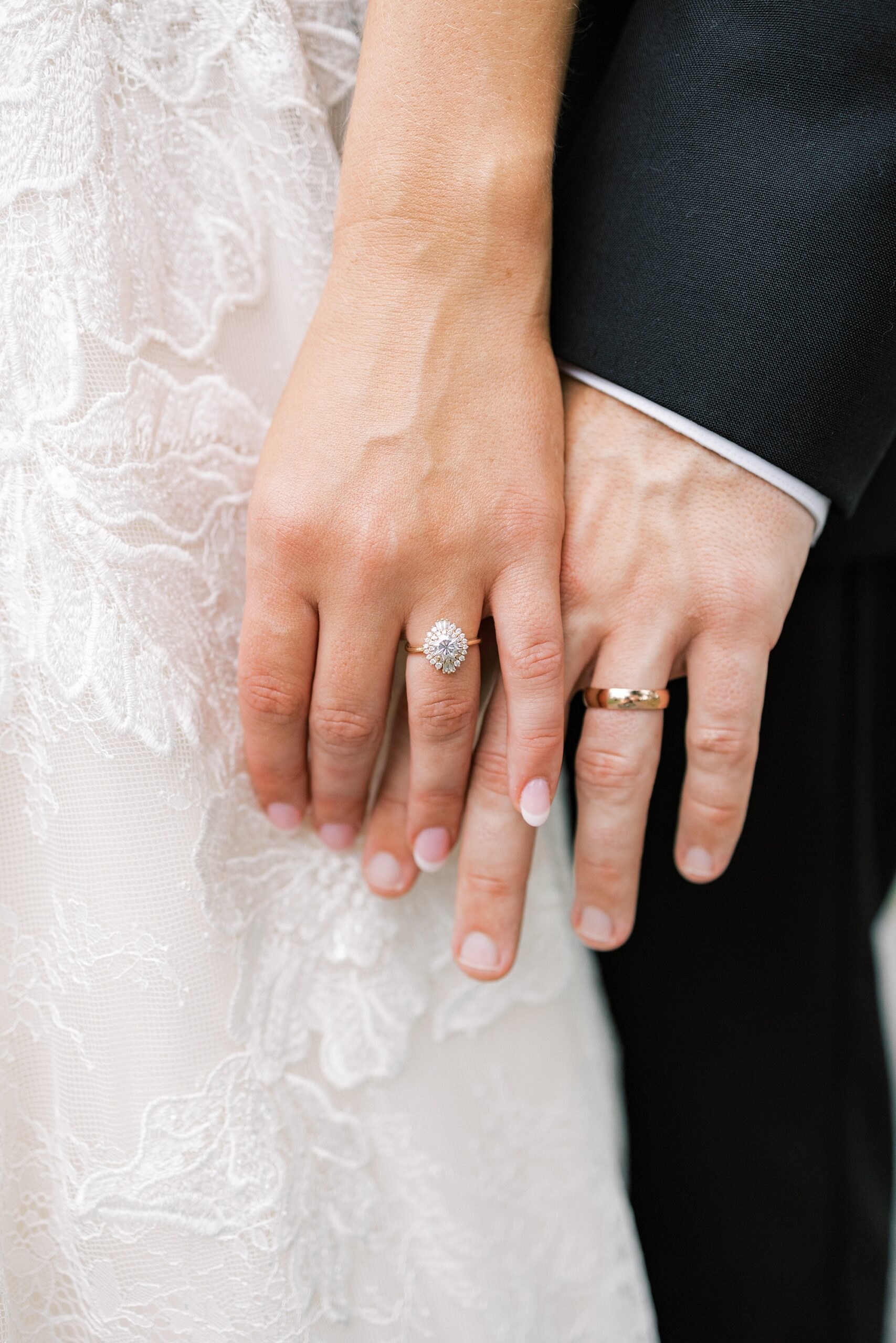 bride and groom hold hands showing off rings