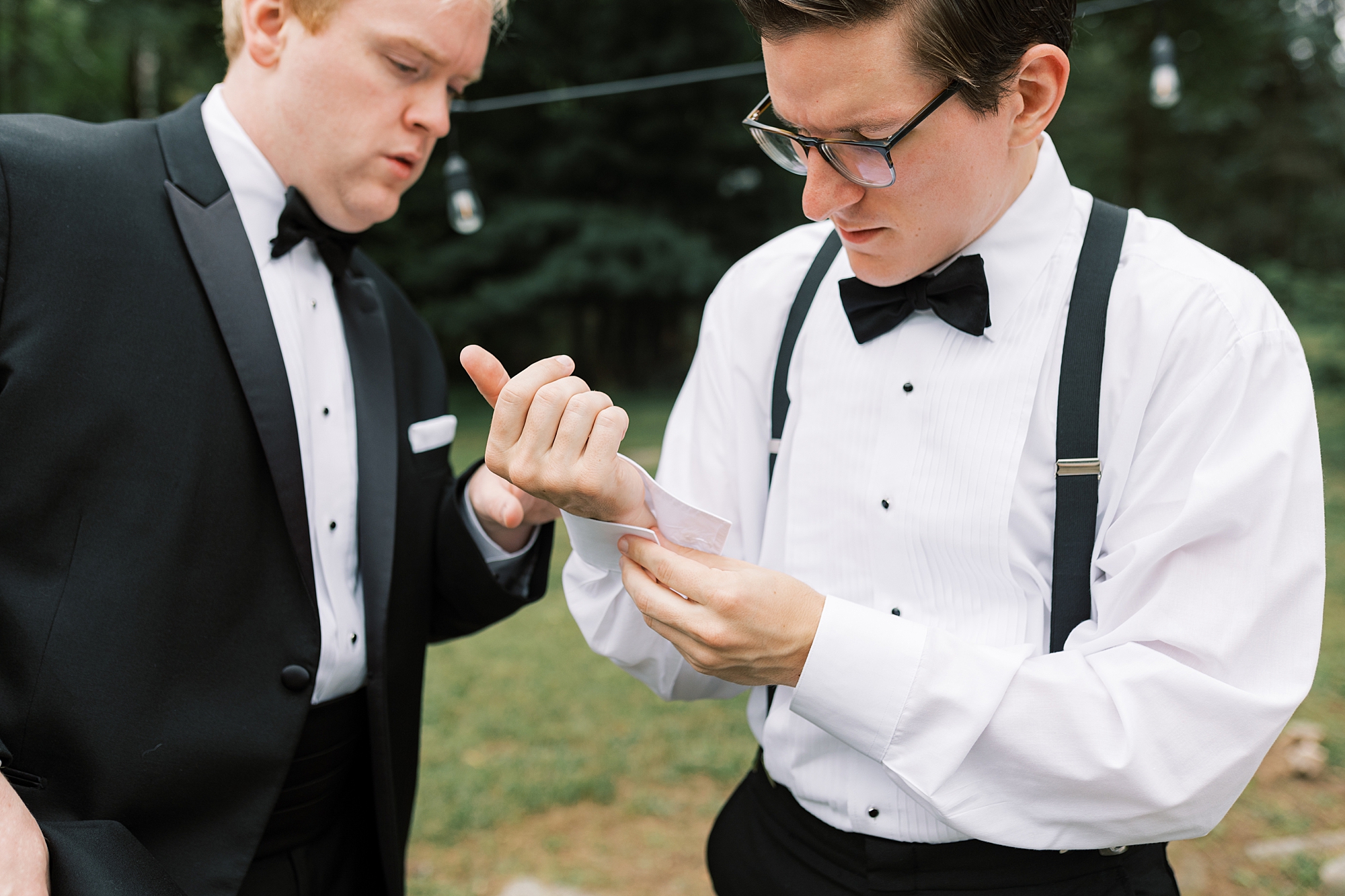 groomsman helps groom with cufflinks at Skytop Lodge