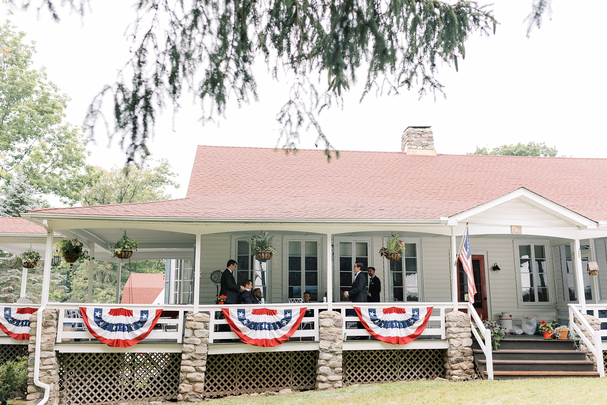 groomsmen relax on porch at Skytop Lodge before wedding