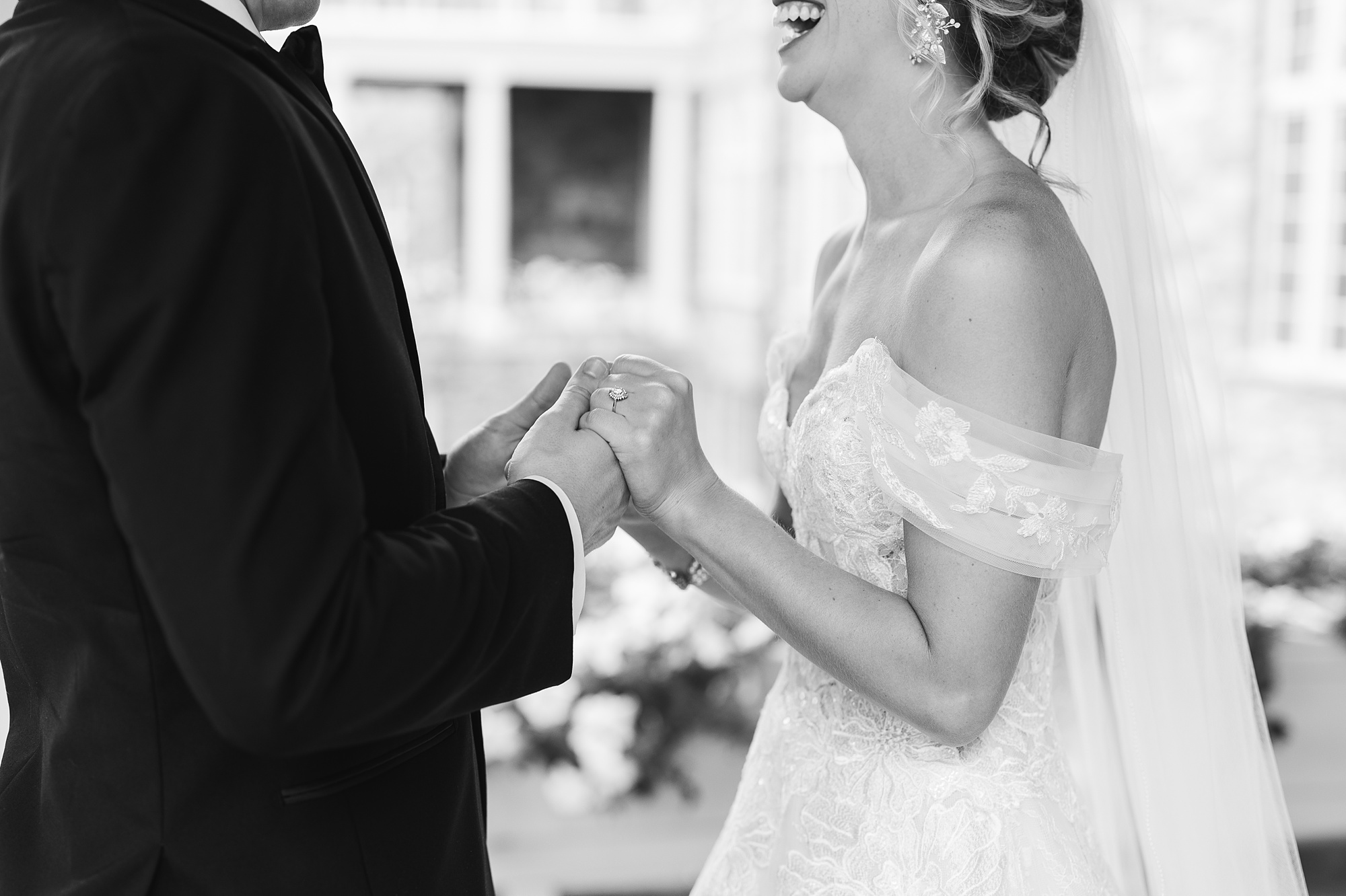 newlyweds laugh holding hands during first look
