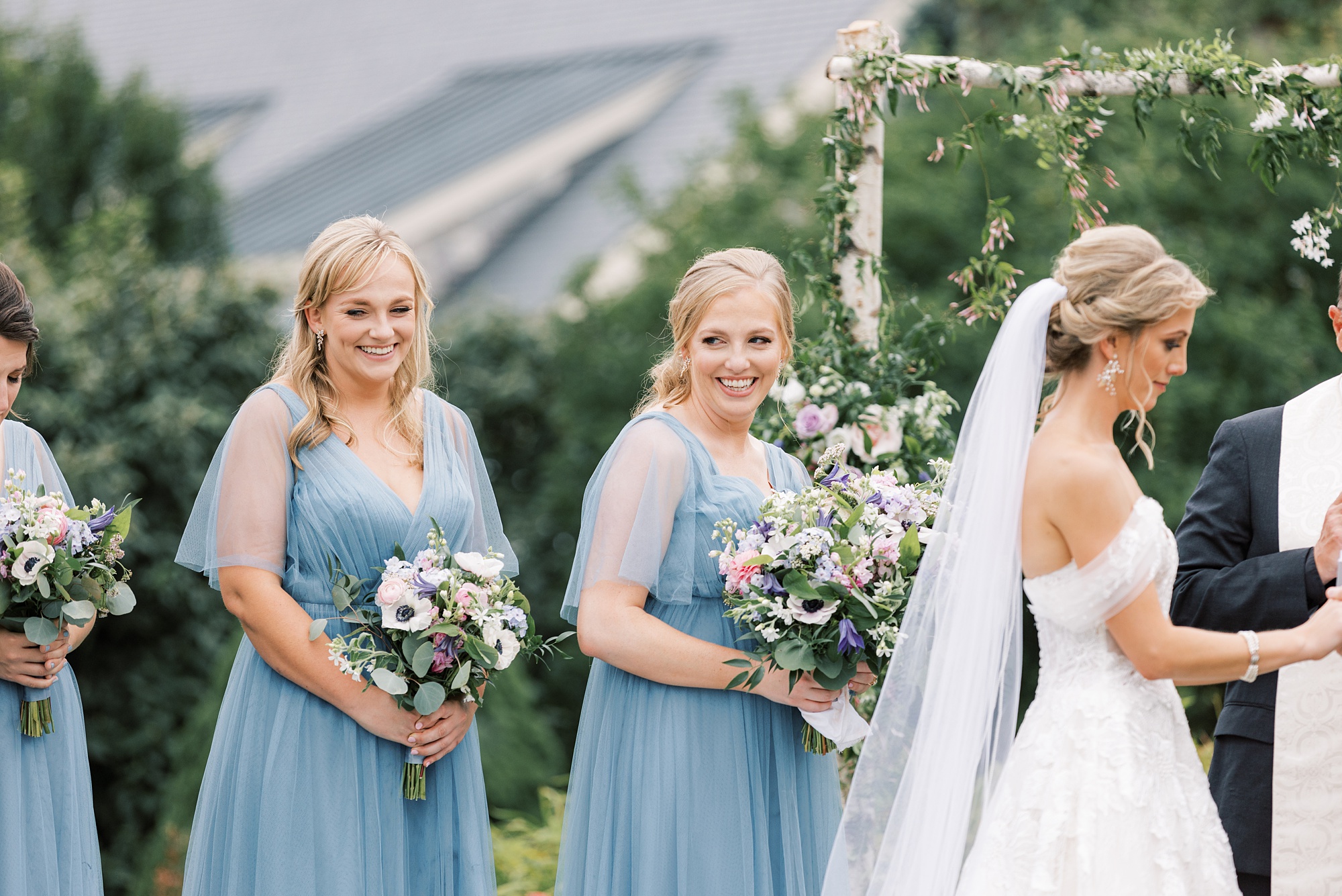 bridesmaids smile during wedding ceremony on lawn at Skytop Lodge