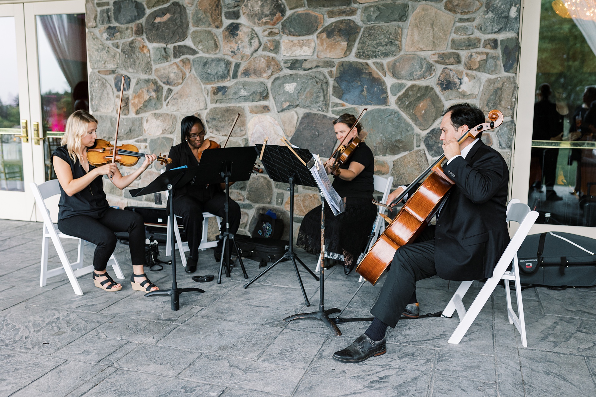 string quartet plays during cocktail hour on patio at Skytop Lodge