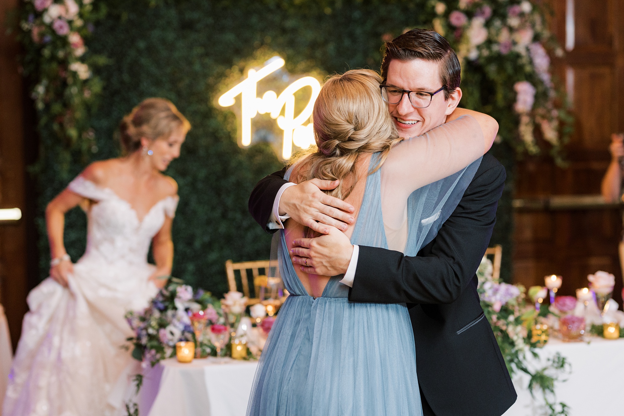 groom hugs bridesmaid after toast during Skytop PA wedding reception