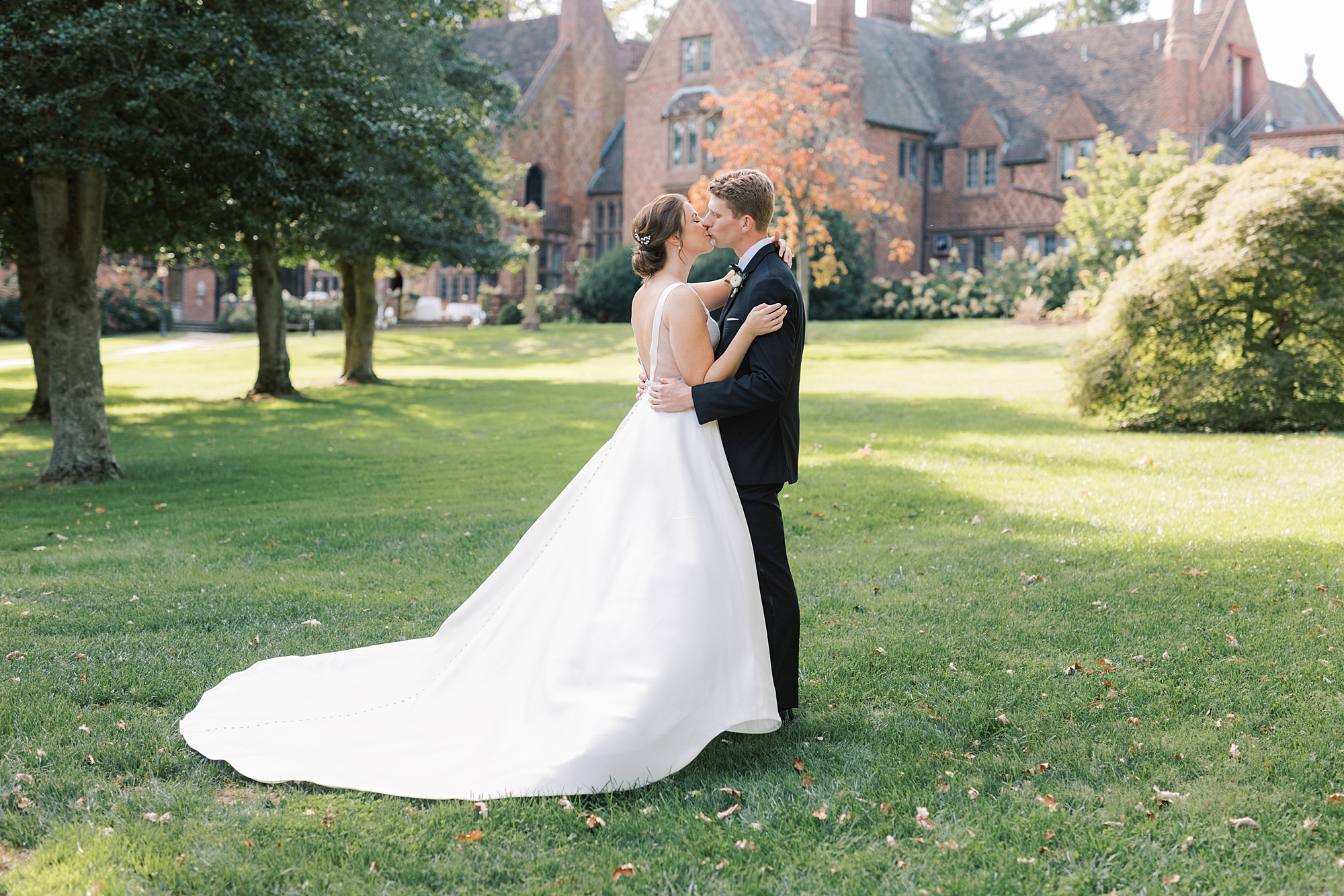 bride and groom kiss on the lawn at Aldie Mansion