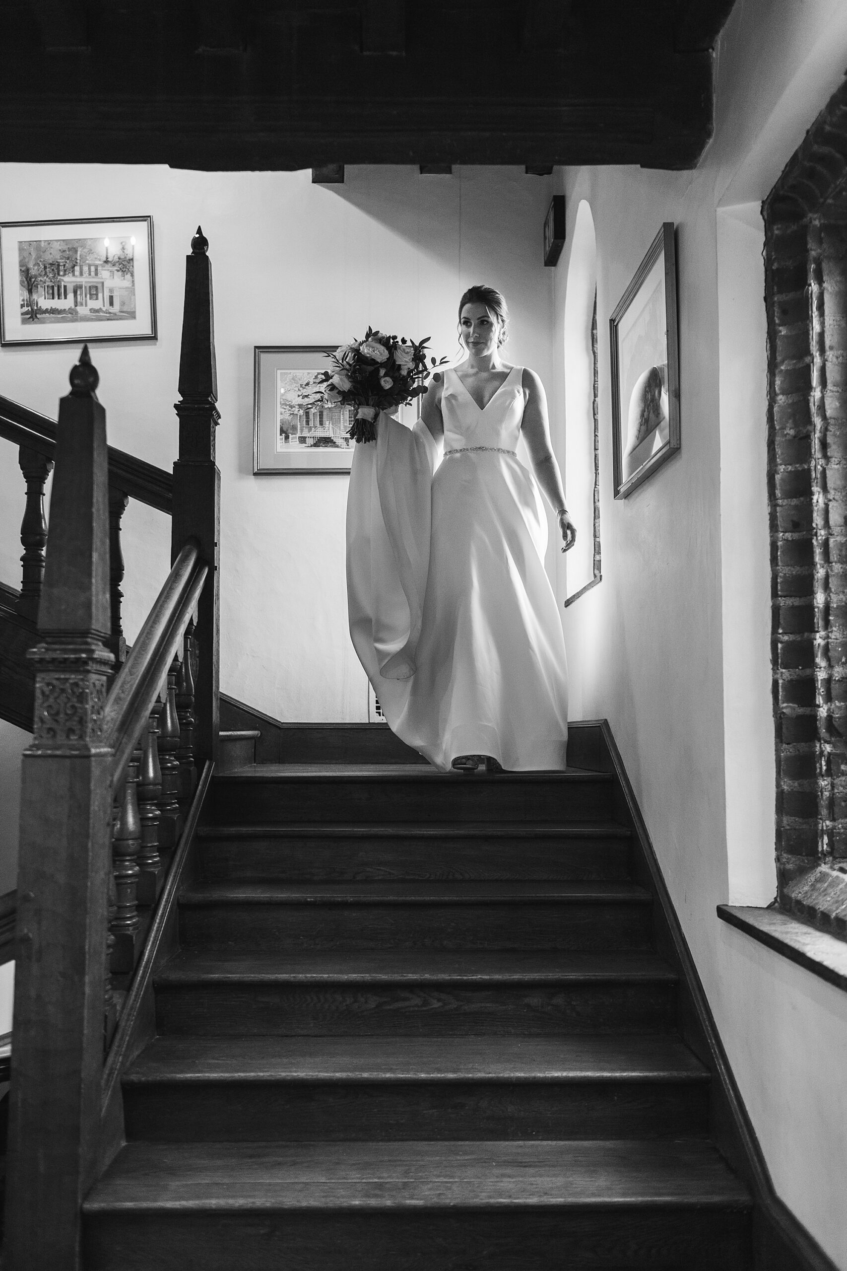 bride walks down steps inside Aldie Mansion