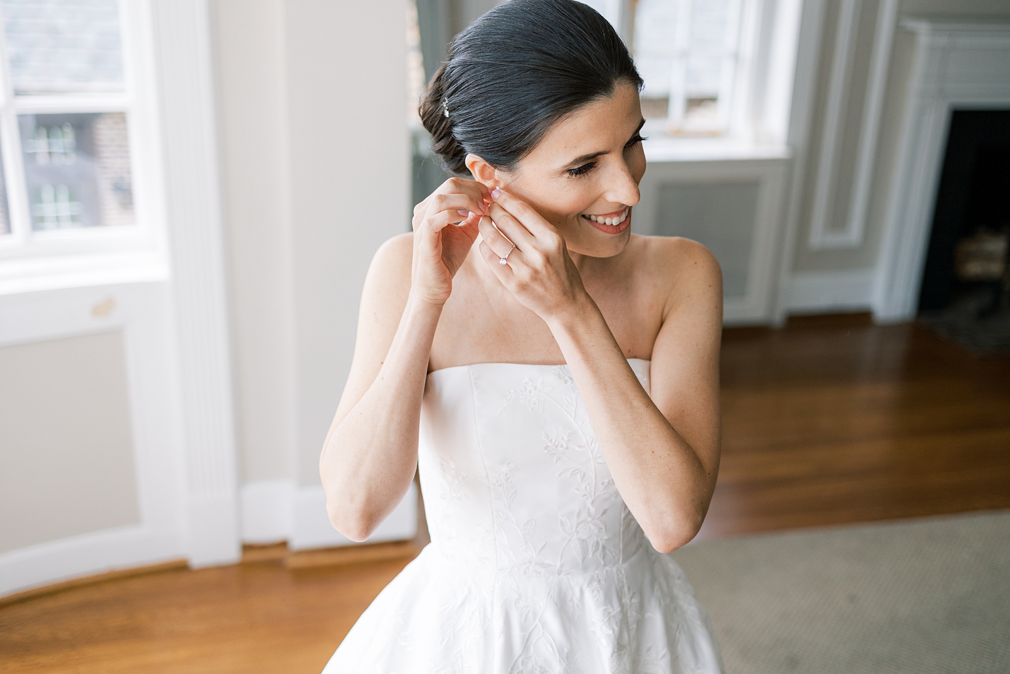 bride adjusts earrings before Greenville Country Club wedding day