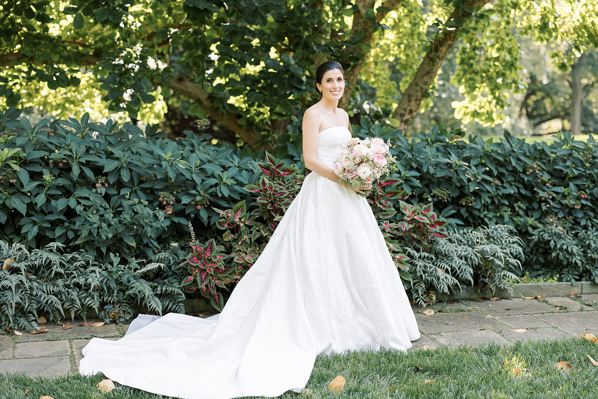 bride stands in gardens at Greenville Country Club