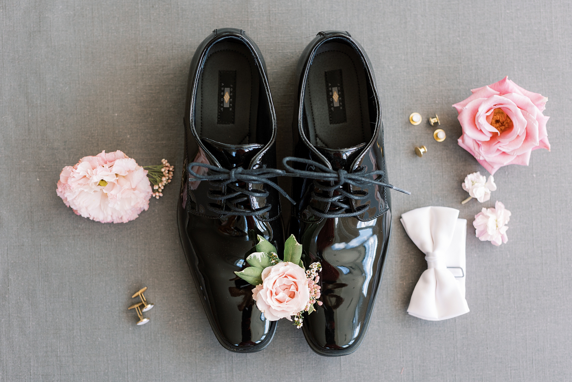 black shoes for groom with pink flowers 
