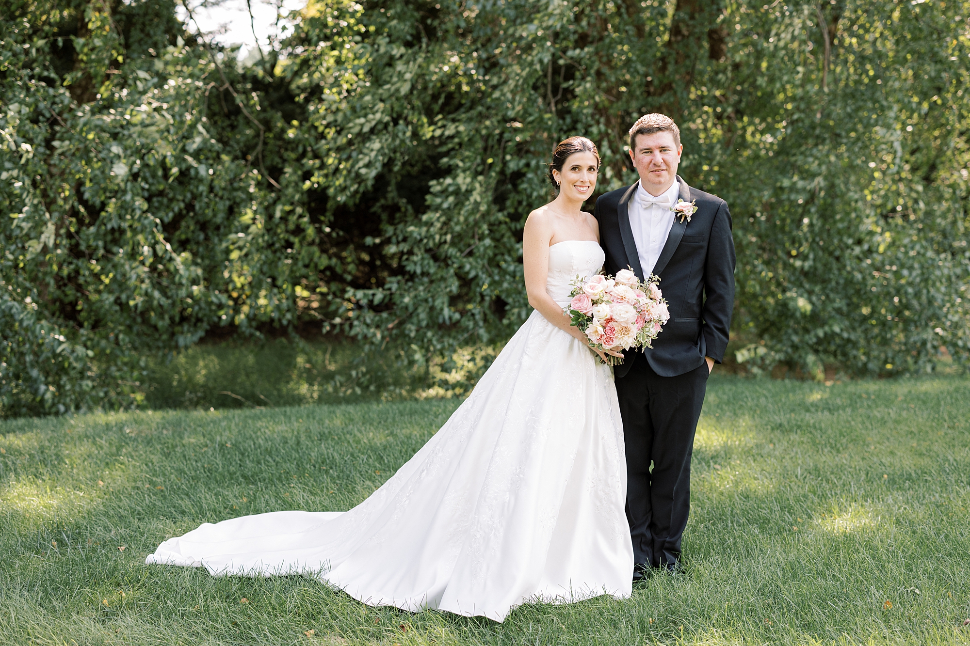 newlyweds stand together on lawn at Greenville Country Club