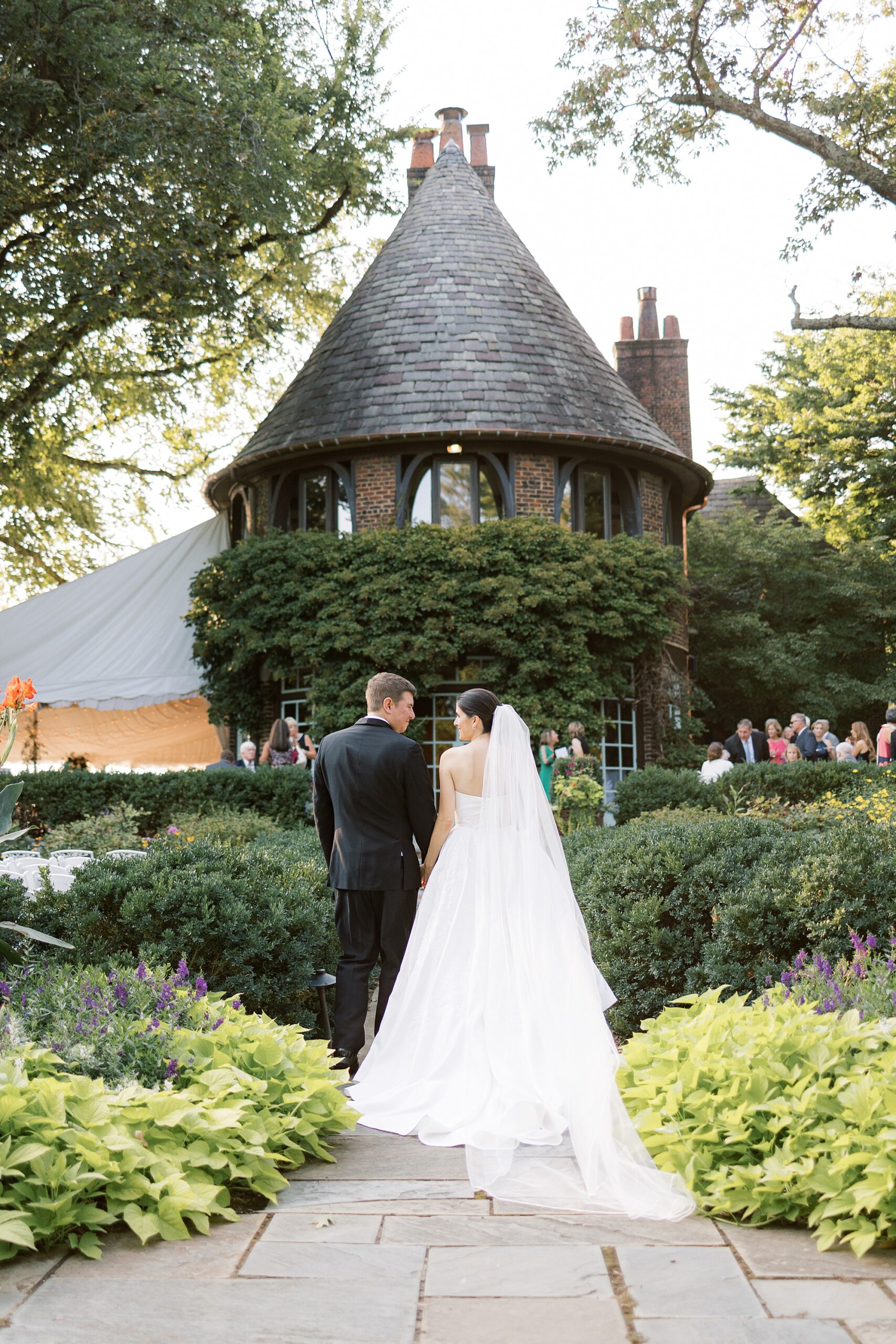 bride and groom walk forward turret at Greenville Country Club